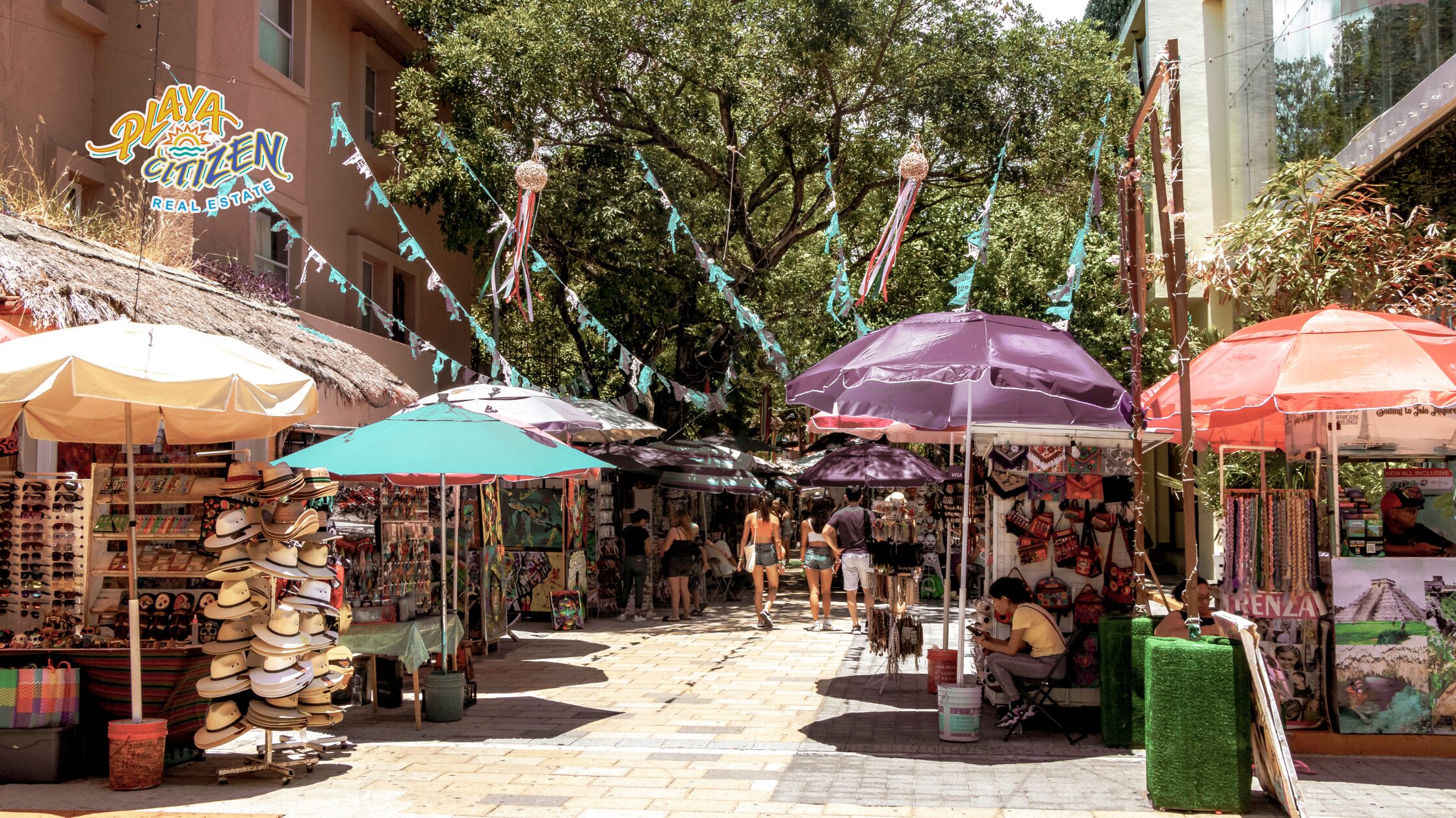 A view of modern apartments in Playa del Carmen at sunset, raising the question of whether it's a good time to invest in real estate in the city.
